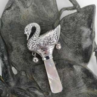 The wonderful swan from a fairy tale as a childrens rattle in silver