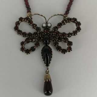 Beautiful butterfly necklace in gold and silver with garnet stones and pearls