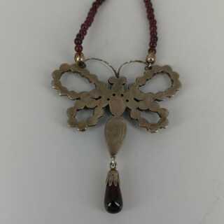 Beautiful butterfly necklace in gold and silver with garnet stones and pearls