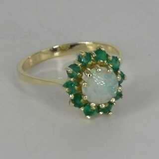 Magnificent cocktail ring in gold with an opal and many emeralds