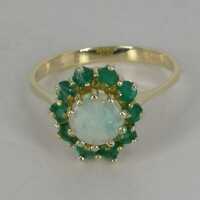 Magnificent cocktail ring in gold with an opal and many emeralds