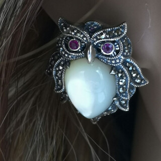 Ear studs richly set with gemstones in the shape of owls
