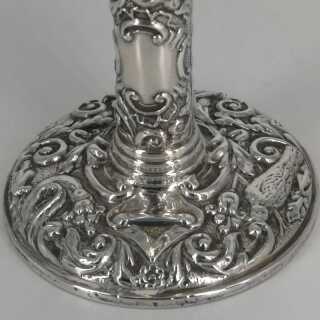 Pair of candlesticks in silver with rich relief decoration