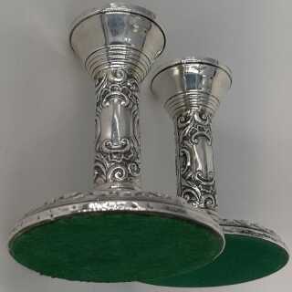 Pair of candlesticks in silver with rich relief decoration